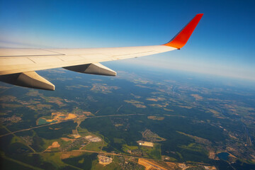 Classic image through aircraft window onto wing. Flight view over Russia
