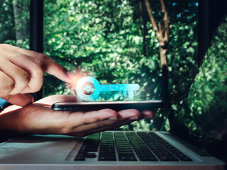 Two steps authentication concept. Virtual key icon on smartphone in hand with laptop for validate...
