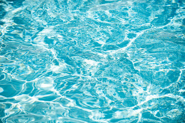 Abstract ripple wave and clear turquoise water surface in swimming pool, blue water wave for background and abstract design.