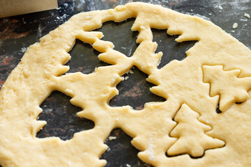 preparation of Christmas cookies from shortbread dough, carved in the shape of a Christmas tree