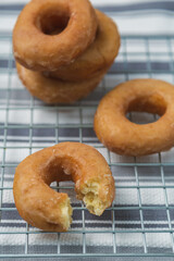 Delicious donuts on iron griddle covered with cloth