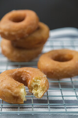 Delicious donuts on iron griddle covered with cloth