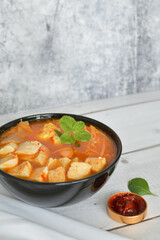 Korean Kimchi jjigae soup with a side of red chili paste