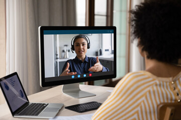 African American customer woman talking to support service employee, operator on video call. Female...