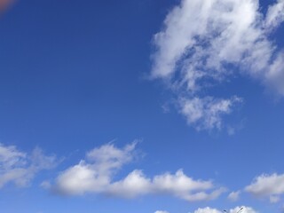 Naklejka na ściany i meble Autumn sky, white clouds in blue sky, background