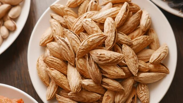 almonds nuts with shell in a white plate