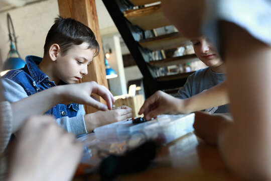 Brothers Making Bracelets At Workshop