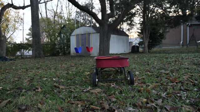 Children toy wagon in autumn yard