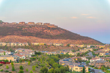 Fototapeta na wymiar Houses on top and at the bottom of a hill at San Diego, California