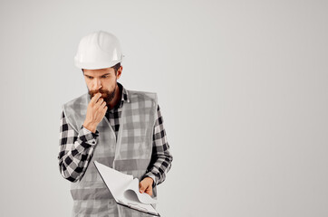 male builder with documents and drawings blueprints isolated background