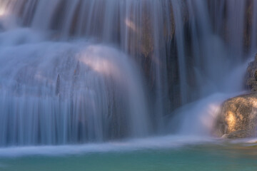 Fototapeta na wymiar Ethereal waterfall in Erawan National Park in Kanchanaburi Province Thailand