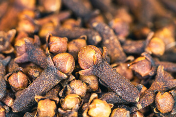 Clove dried spices. Cloves background. Pile of dried cloves in macro shot.