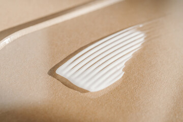White cream texture on a beige background.