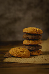 Stack of delicious chocolate and mocha cookies on wooden table.