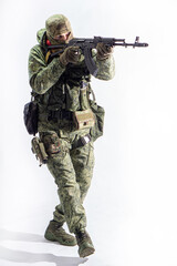 Members of the special purpose unit. A Russian special forces soldier with assault rifle aiming from a machine gun on a white background