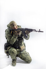 Members of the special purpose unit. A Russian special forces soldier with assault rifle aiming from a machine gun on a white background
