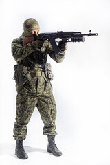 Members of the special purpose unit. A Russian special forces soldier with assault rifle aiming from a machine gun on a white background