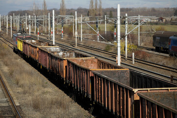 Empty old freight train wagons and in a station.