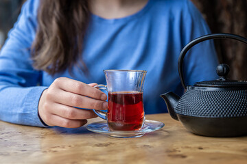 Close up of tea and black textured cast iron teapot.