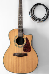 Acoustic guitar on a white background, top view, copy space.