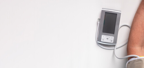 Blood pressure tool and hand. Medical banner with copy space on white background.