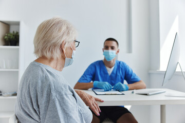 elderly patient at the doctor's and nurse's appointments in the medical office