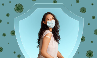 Smiling millennial european lady in protective mask shows shoulder with band aid after vaccination