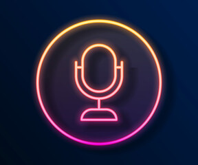 Glowing neon line Microphone icon isolated on black background. On air radio mic microphone. Speaker sign. Vector