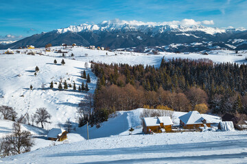 Fabulous winter scenery with mountains and Pestera village, Romania