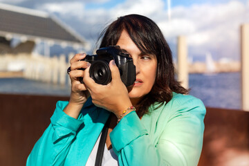 Woman taking a photo with her digital camera, Professional photographer shooting a picture.