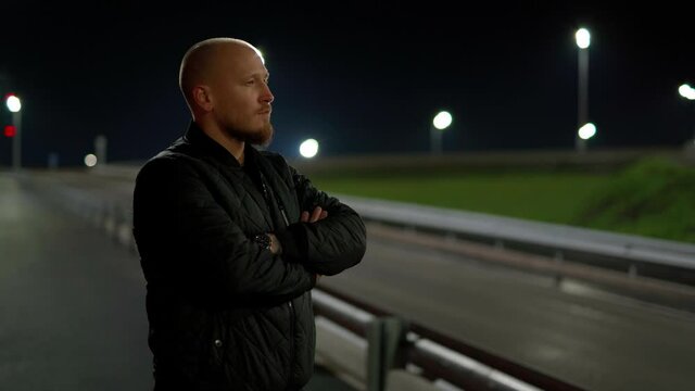 Russia,Yamalo-Nenets Autonomous Okrug, Novy Urengoy city, October 17, 2021, 22:00, a 35-year-old guy smokes a cigarette in the courtyard of a house in the Vostochny microdistrict at his white car