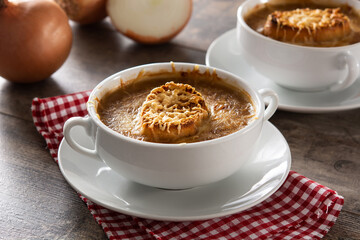 Traditional french onion soup on wooden table	
