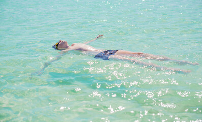 Teenage boy swimming in ocean, Children lifestyle. Enjoy the life, vacation concept