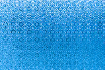 Abstract blue stained glass flower shape design as background.