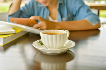 White coffee cup on wood table with light shade on tabletop