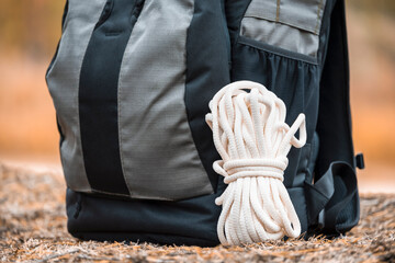 Smoked rope with backpack in the forest. Hiking equipment.