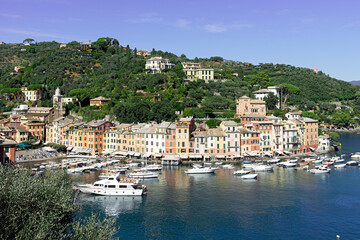 Fototapeta na wymiar Portofino is a fishing village on the Ligurian Riviera south-east of Genoa, pastel-colored houses overlooking the cobbled square overlooking the harbor