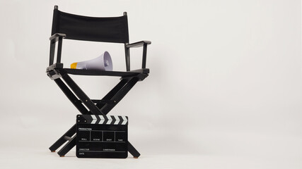 Black director chair and Clapper board with yellow megaphone on white background