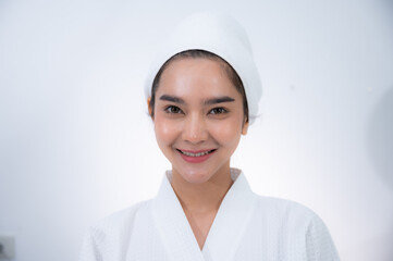 young Asian woman making treatment cosmetic beauty therapy on a face at cosmetological clinic