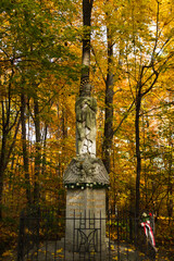 Religious statue in the middle of an autumn forest