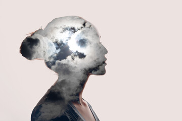 Psychology and woman mental health concept. Multiple exposure clouds and sun on female head...