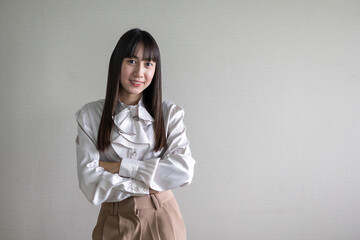 Portrait young asian businesswoman looking at the camera standing in modern office.