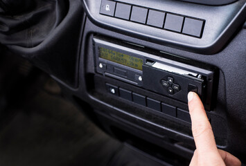 Driver opening a printer on a digital tachograph in a van. Paper roll Replacement in a truck...