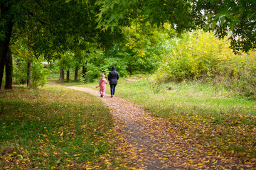 Grandmother and granddaughter in the autumn park.