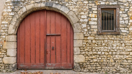 Fototapeta na wymiar Antique door on a stone façade