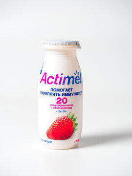 20.10.2021 , Moscow, Russia. Close-up of actimel drinking yogurt with strawberry flavor in a plastic bottle on a white background. An isolated object, a product for Russia. Front view