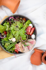 salad with tuna and quail eggs on a picnic