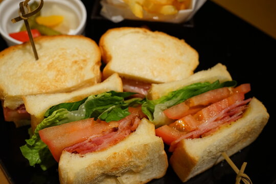 French Fries and Delicious BLT sandwich made of white bread, ham and lettuce on plate - BLT サンドウィッチ ピクルス フライドポテト - Powered by Adobe