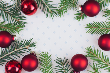 Christmas composition. Frame made of christmas treepine branches, toys on white background. Flat lay, top view, copy space