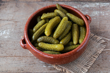 Pickled gherkins on rustic background